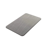 Close up of the soft diatomaceous earth surface and sleek cut edge of the grey mat