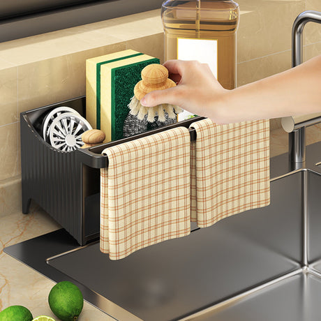 Compartments of the sink caddy holding assorted cleaning tools