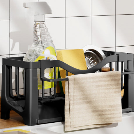 Compartments of the sink caddy holding assorted cleaning tools