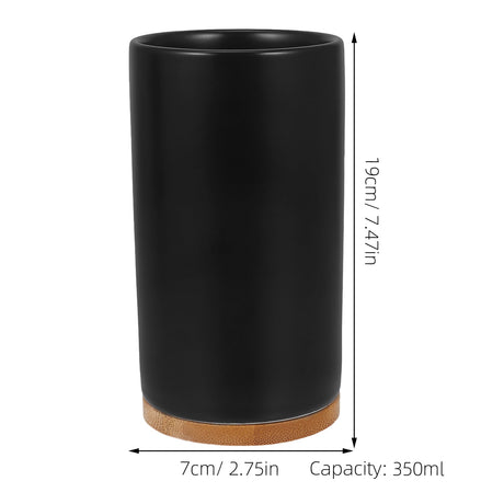 Black ceramic pump soap dispenser standing on a slim bamboo tray