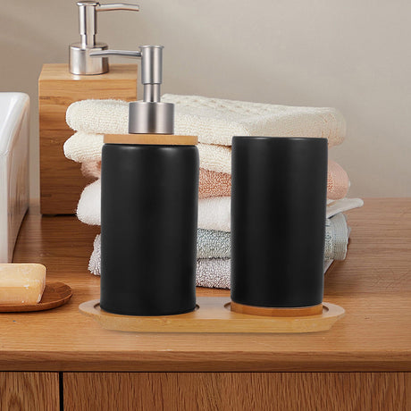 Black soap dispenser and bamboo tray styled on a bathroom vanity
