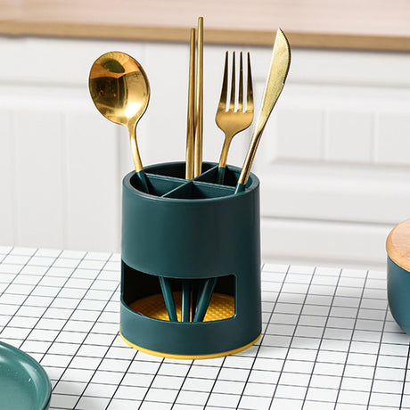 Green compartment organiser used to store makeup brushes on a vanity