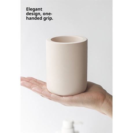 Drying stone toothbrush holder filled with toothbrushes and a tube of toothpaste