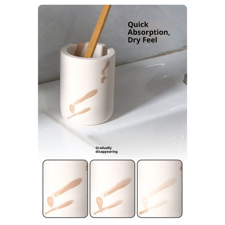Beige toothbrush holder holding an electric toothbrush handle beside a basin