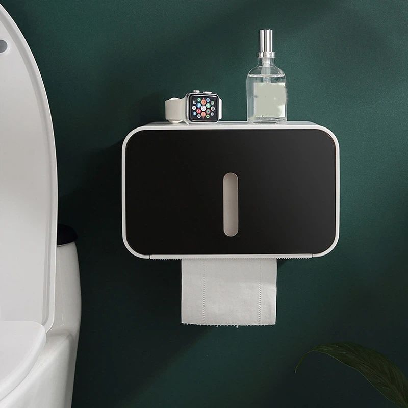 Open housing of the black roll holder showing a standard toilet roll inside