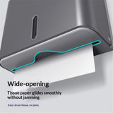 Grey paper towel dispenser opened for refilling with folded hand towels