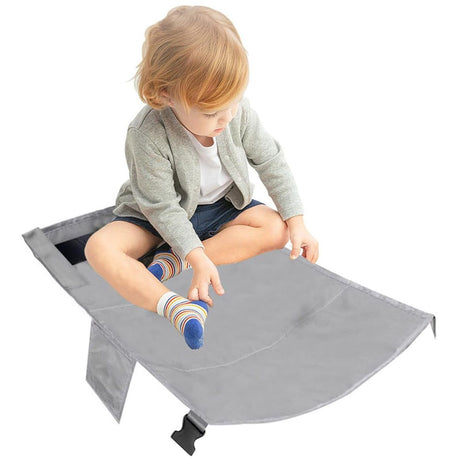 Child resting on airplane travel bed footrest
