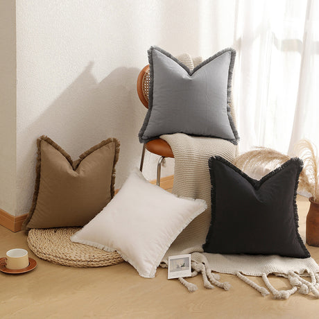 Close up of the textured brown fabric and fringed edge on the cushion cover