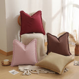 Brown fringed cushion cover styled on a sofa as living room decor