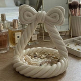 Pink bow-shaped jewellery tray with twisted rope detail