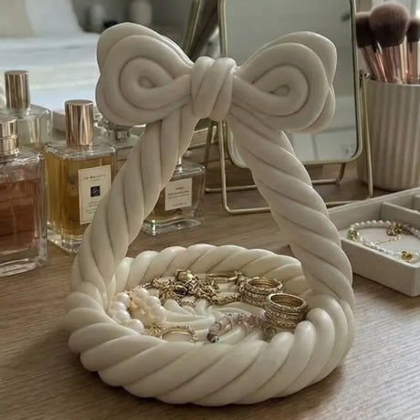 Pink bow-shaped jewellery tray with twisted rope detail