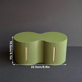 Light green roll storage box beside a toilet with spare rolls inside