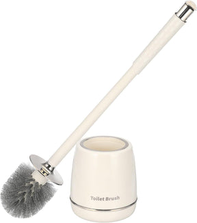 Silver toilet brush and holder set standing beside a toilet