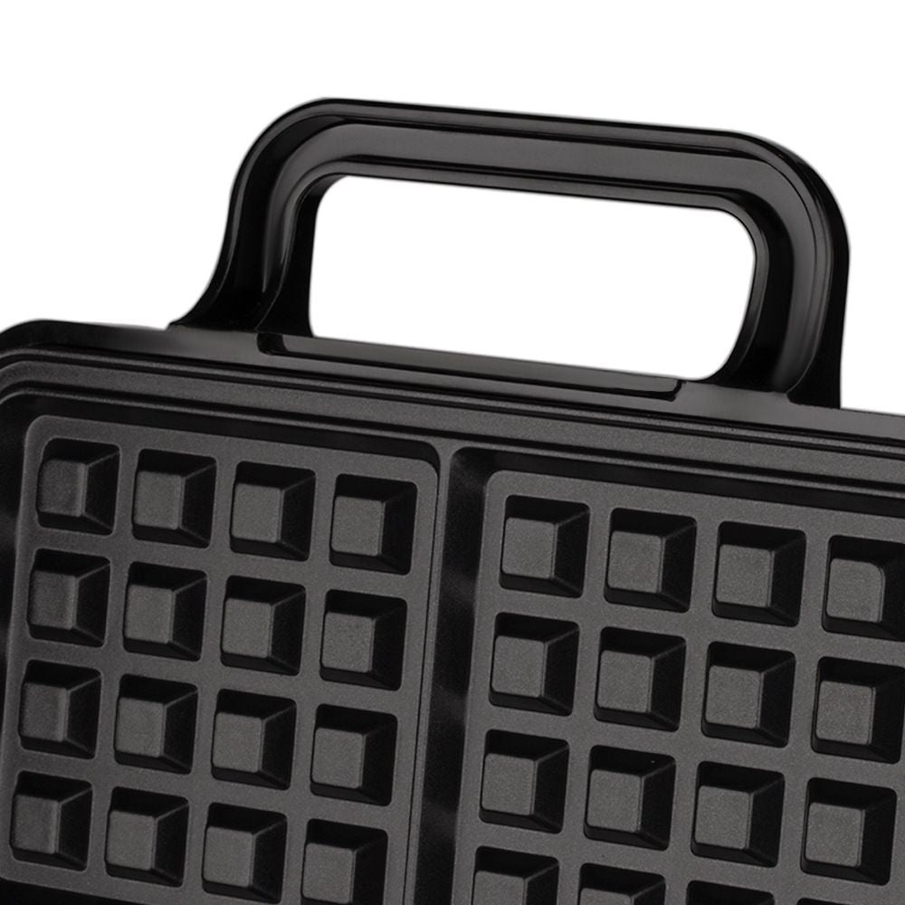 Batter poured into the four grid waffle plates