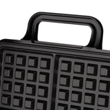 Batter poured into the four grid waffle plates