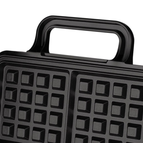 Batter poured into the four grid waffle plates
