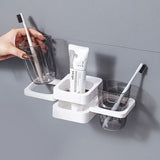 White organiser holding toothbrushes, toothpaste and a mouthwash cup