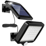 Solar motion sensor wall light with split panel lighting a driveway
