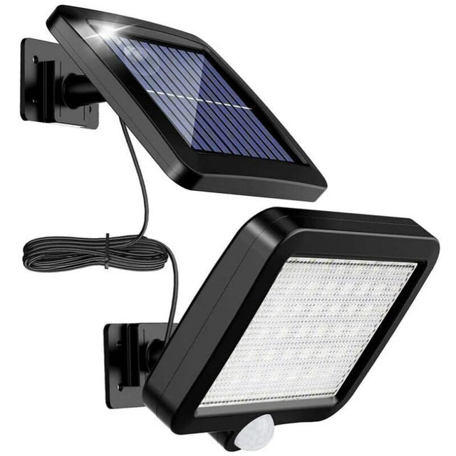 Solar motion sensor wall light with split panel lighting a driveway