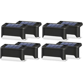 Black shell warm white solar step lights along outdoor decking steps
