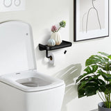 Toilet roll on the holder bar beneath the 18 cm black shelf