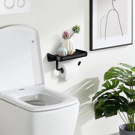 Toilet roll on the holder bar beneath the 18 cm black shelf