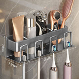 Grey aluminium wall mounted electric toothbrush holder with four cups above a bathroom basin