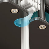 Grey toothbrush holder holding electric toothbrushes and cups on a tiled wall