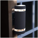 Black up and down outdoor wall light on an exterior wall