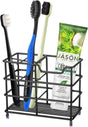 Black stainless steel freestanding toothbrush holder with four brush slots on a bathroom vanity