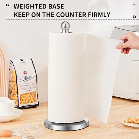 Paper towel holder standing on a kitchen benchtop beside a sink