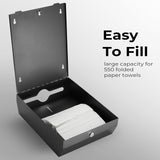 Black paper towel dispenser mounted on a washroom wall beside a basin