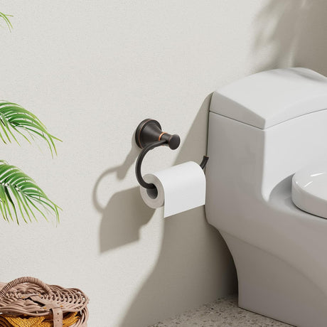Bronze finish toilet roll hanger holding a roll beside the toilet
