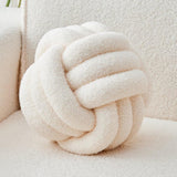 Blackheath ivory white lambswool knot cushion on a sofa