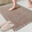 Tan waffle weave bath mat, 46 x 76 cm, laid on a bathroom floor