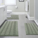 Sage striped chenille bathroom rug set of three pieces laid out on a floor