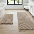 Cream waffle bath mat set of two with tassels laid on a bathroom floor