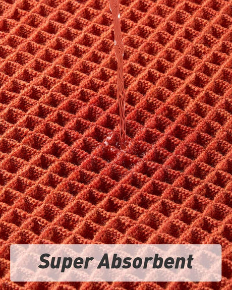 Tasselled end detail of the large orange waffle bath mat