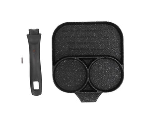 Black three section non stick egg frying pan with two egg wells and a flat cooking area