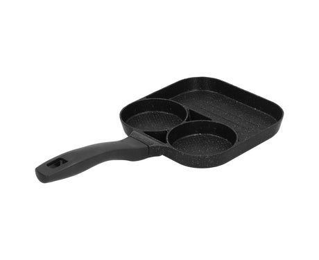Three section frying pan on a gas cooktop cooking a breakfast