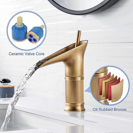 Antique brass waterfall basin mixer tap installed on a bathroom vanity basin