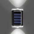White solar fence lights mounted along a garden fence at dusk
