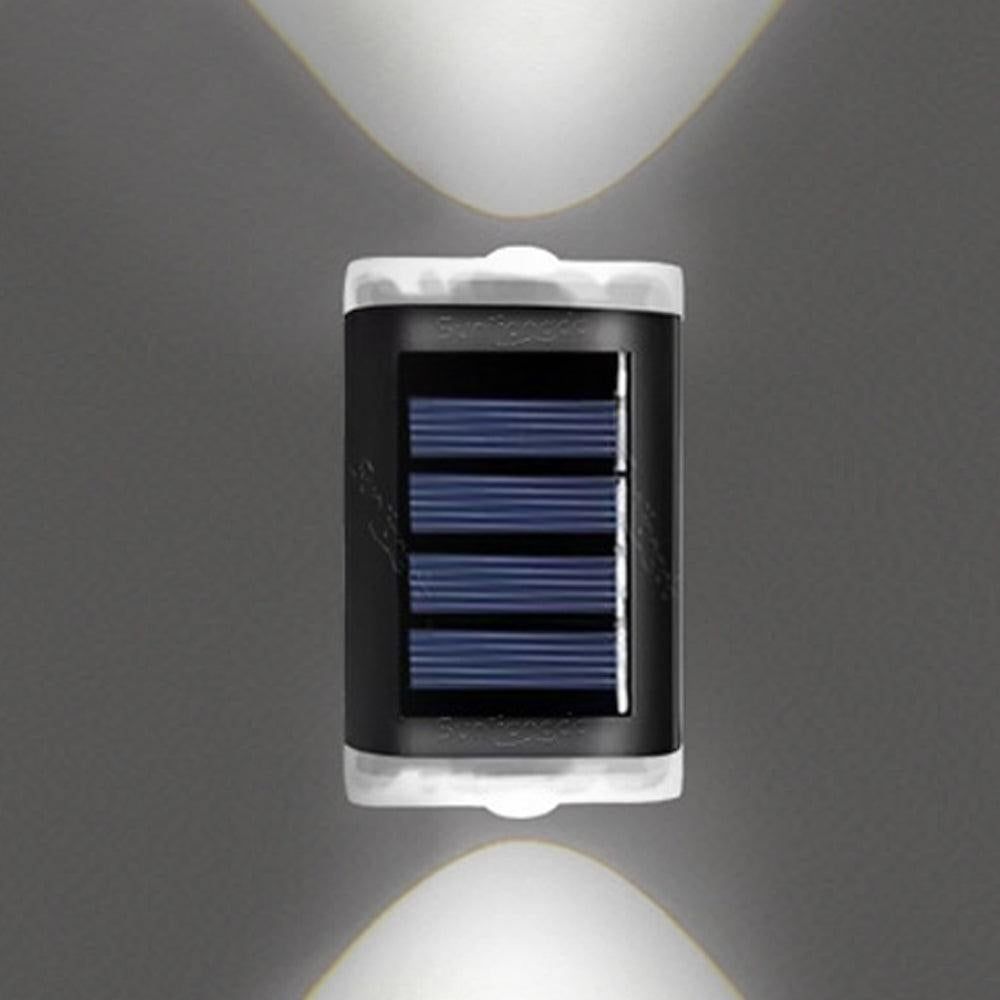 White solar fence lights mounted along a garden fence at dusk