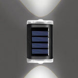 White solar fence lights mounted along a garden fence at dusk