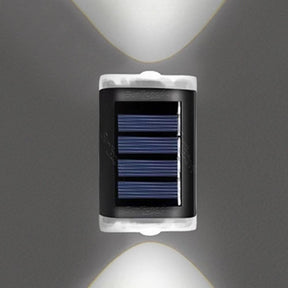 White solar fence lights mounted along a garden fence at dusk