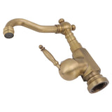Water flowing from the heightened brushed brass basin mixer