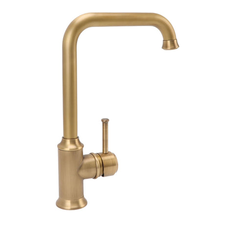 Vintage brass tap in use with water running into a basin