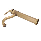 Tall copper mixer tap in use with water running into a vessel basin