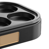 Six hole pan on a cooktop with eggs cooking
