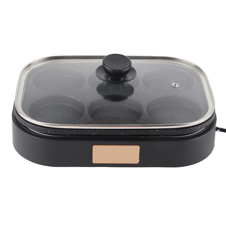 Non stick coated cooking surface of the six hole pan shown close up